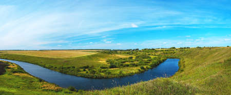 Beautiful rural summer nature landscape.Sunny view of small river and green woods.Amazing blue sky...