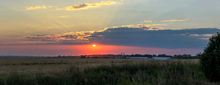 Summer sunset rural landscape with dramatic sky over the fields.の写真素材