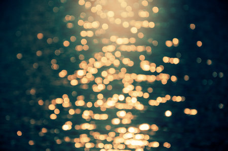 Abstract blurred photo of moonlight reflection on sea water surfaceの写真素材
