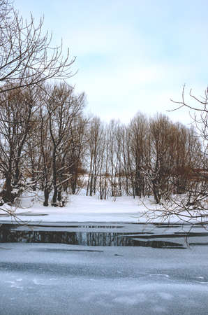 Spring rural landscape with calm river and melting iceの写真素材