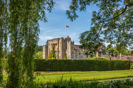Leaves framed view to Hever castle in England. The oldest part of the castle dates to 1270 and in 1462 it was converted into a manor.のeditorial素材