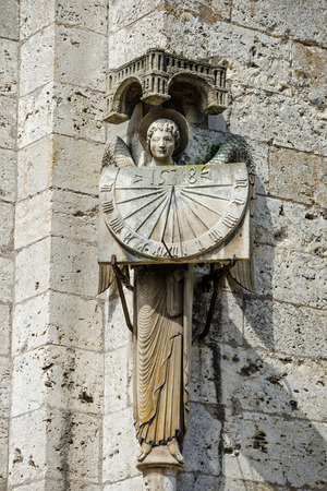 Chartres, France - April 19, 2013: Statue of angel holding sundial at Cathedral Our Lady of Chartres, France - one of the finest examples of French Gothic architecture, constructed during the 13th century.のeditorial素材