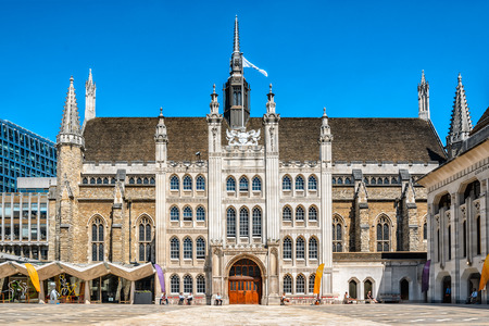 London, United Kingdom - July 23, 2012: Facade of Guildhall of the City of London as seen on 23rd of July, 2012. Some people are having rest at the building.のeditorial素材