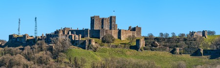 Dover, United Kingdom - March 25, 2016: Panoramic view to Dover Castle and St Mary church  with copy space in sky. Castle was founded in the 11th century for protect the town and surrounding area for hundreds of years. Also known as Key to England.のeditorial素材