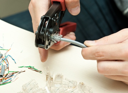 man making a special network cableの写真素材