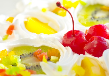 holiday cake decorated with cherries, orange slices and kiwi, close-up, dofの写真素材