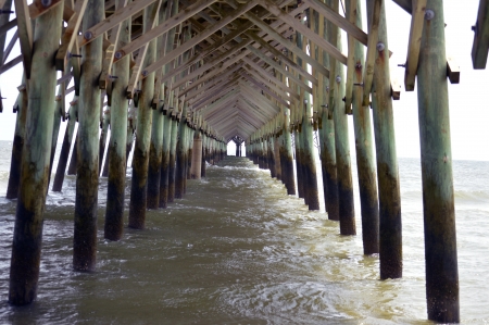 The pillars under the pier at the beachの写真素材
