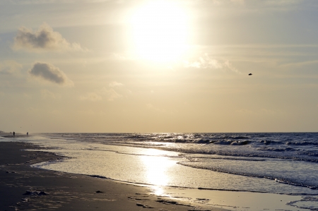 The beach with the sun coming upの写真素材