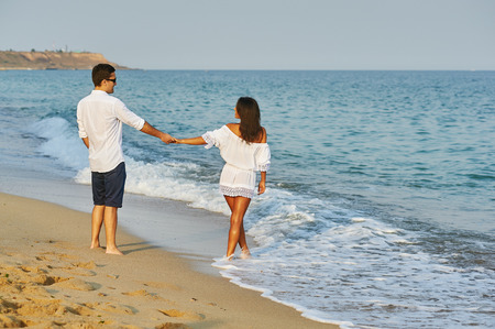 Beautiful romantic couple on the sea shoreの写真素材