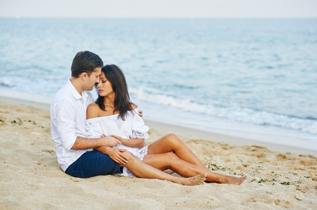 Beautiful romantic couple on the sea shoreの写真素材