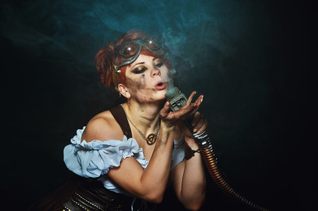 Steam-punk girl portrait. fantasy portrait. The girl mechanic with your metal friendsの写真素材