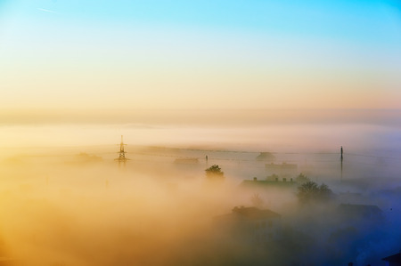 city ??skyline at dawn surrounded by fog