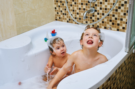 brother and sister fun take water treatments. Children in the bathroomの写真素材