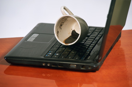 broken laptop filled coffeeの写真素材