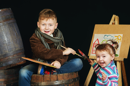 Boy artist with palette and brushesの写真素材