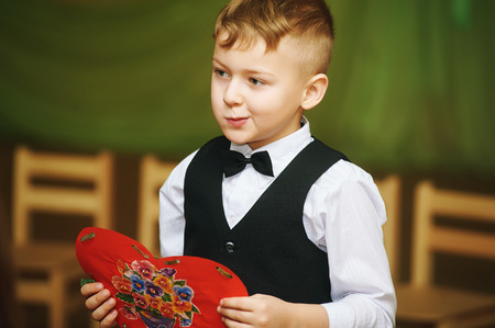 A little boy holds a gift for mom