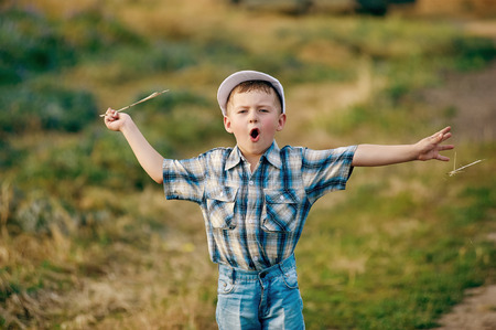 Young boy playing in the fields in rural areas.の写真素材
