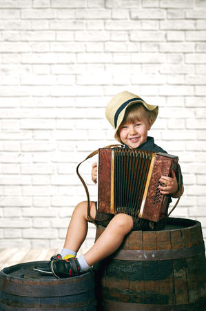 Little gay boy with accordionの写真素材