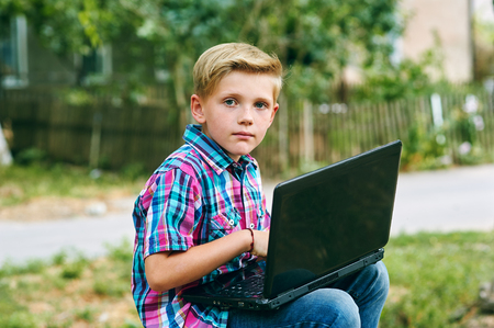 student work using a laptop outside of school . Education conceptの写真素材