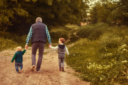 father walks with children in the Parkの写真素材