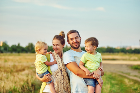 Happy young family together outside in nature.の写真素材