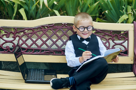 little boy student with a notebook . Homework .の写真素材