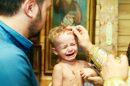 The little boy at the ceremony of baptism of the child in the Churchの写真素材