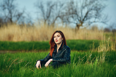 Beautiful redhead girl on a spring walk . Hikingの写真素材