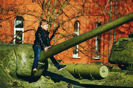 a boy plays on military equipment. Victory dayの写真素材