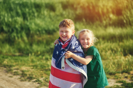 a truly Patriotic children with USA flag . The concept of independence dayの写真素材