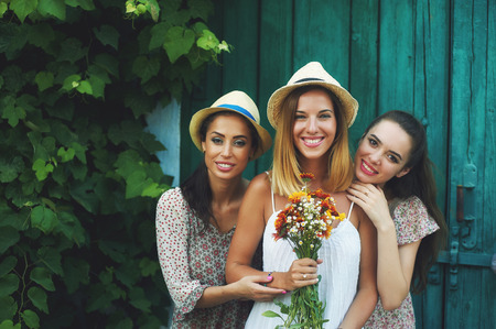 Beautiful girls in summer clothes pose in front of the countryside . The concept of summer fashion clothes.の写真素材