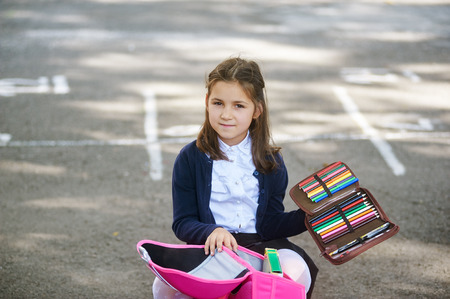 Girl schoolgirl with a backpack and pencilsの写真素材