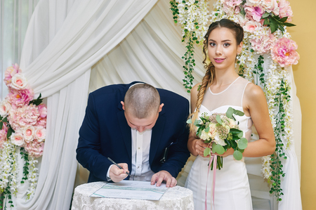 Wedding ceremony. The bride and groom , leaving their signaturesの写真素材
