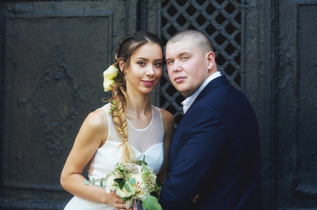 Bridal walk of the bride and groom in the city . Young couple posing for the photographerの写真素材