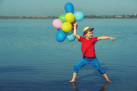 happy boy with balloons on nature.Kids activitiesの写真素材