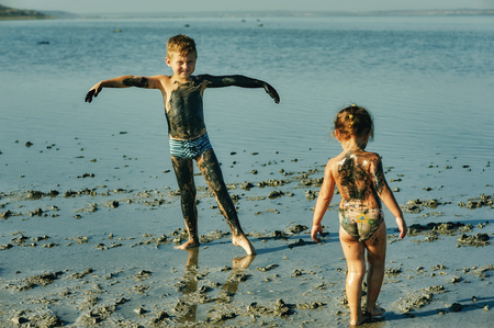 children take mud baths at the resort and having fun with mud . children in the Spaの写真素材