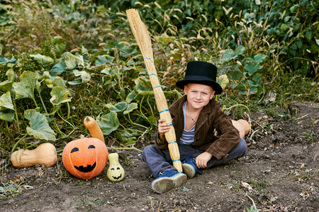 Boy holding a pumpkin on Halloweenの写真素材