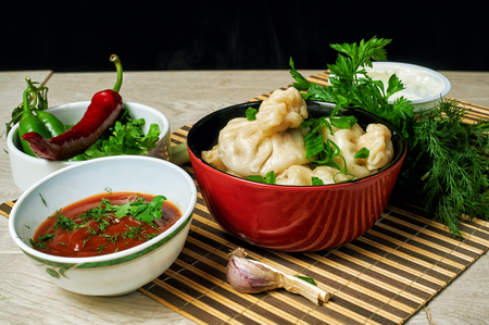 Georgian dumplings Khinkali with meat, herbs and tomato sauce . National cuisineの写真素材