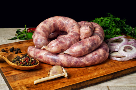 Raw homemade sausage on a wooden table , before cookingの写真素材