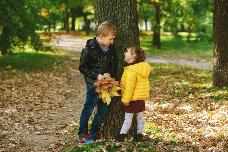 Brother and sister in an autumn Parkの写真素材