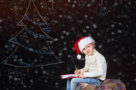Boy writes letter to Santaの写真素材