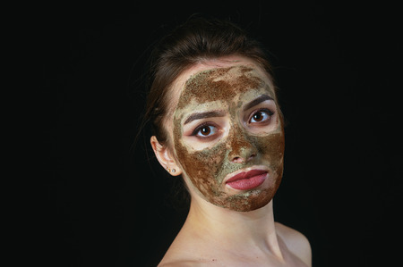 A young woman in a cosmetic mask on her faceの写真素材