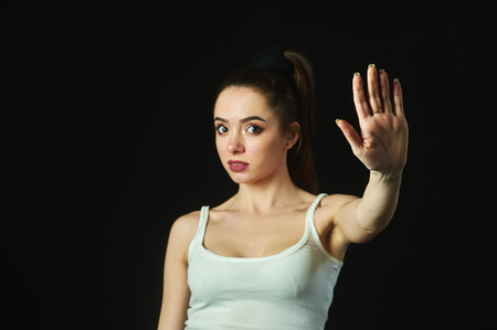 The girl shows a hand gesture stopの写真素材