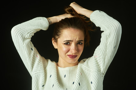The girl holds the damaged hair .The concept of beauty and healthの写真素材