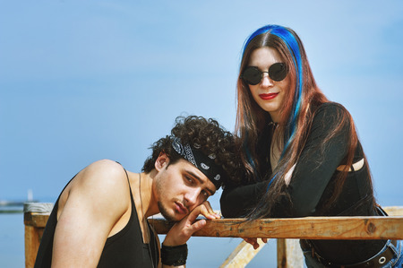 A young man and a woman posing on the street . Love and relationshipsの写真素材