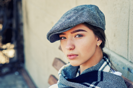 Portrait of a young girl. The girl is dressed in stylish retro clothes. The concept of women's clothingの写真素材