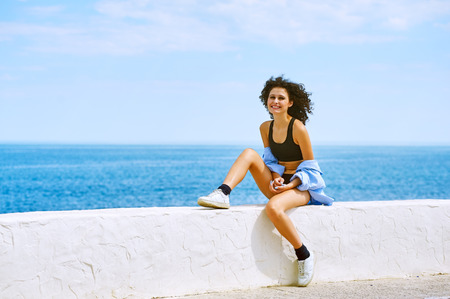 Sexy young woman posing in the seaside.の写真素材