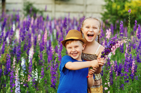 Fun and friendly children in a field of flowersの写真素材