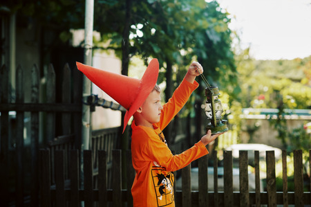 Boy on Halloween day with a lantern in his hands.の写真素材