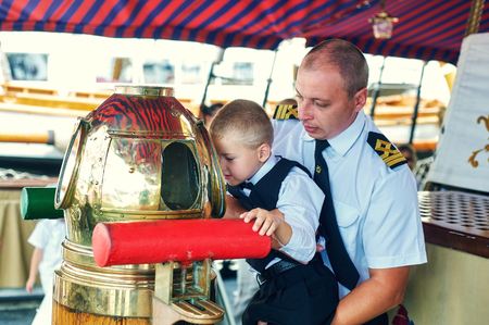 Portrait of father and son . The father of a sailor communicates with the childの写真素材